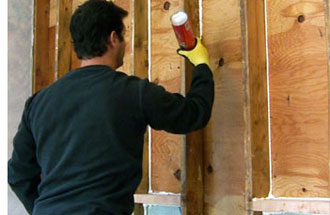 Air sealing a garage wall before insulating