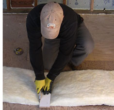 Cutting fiberglass insulation for a wall cavity
