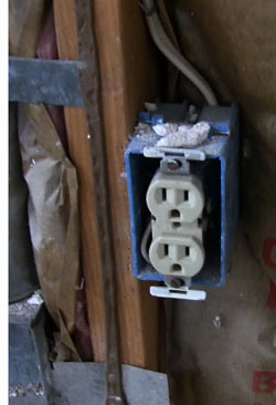 Fiberglass vs. Cellulose - Poor fiberglass installation around outlet